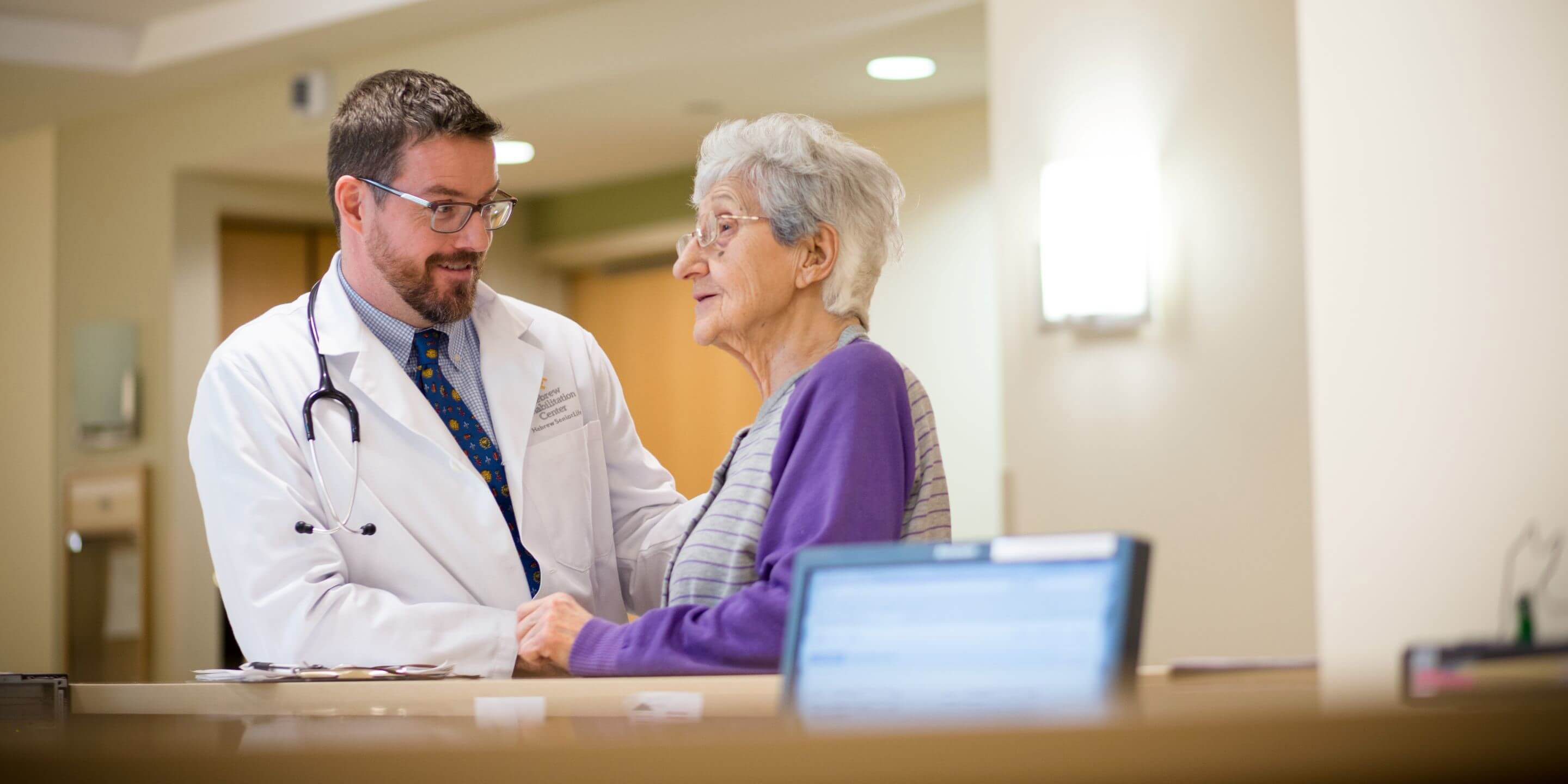 Doctor sitting with woman