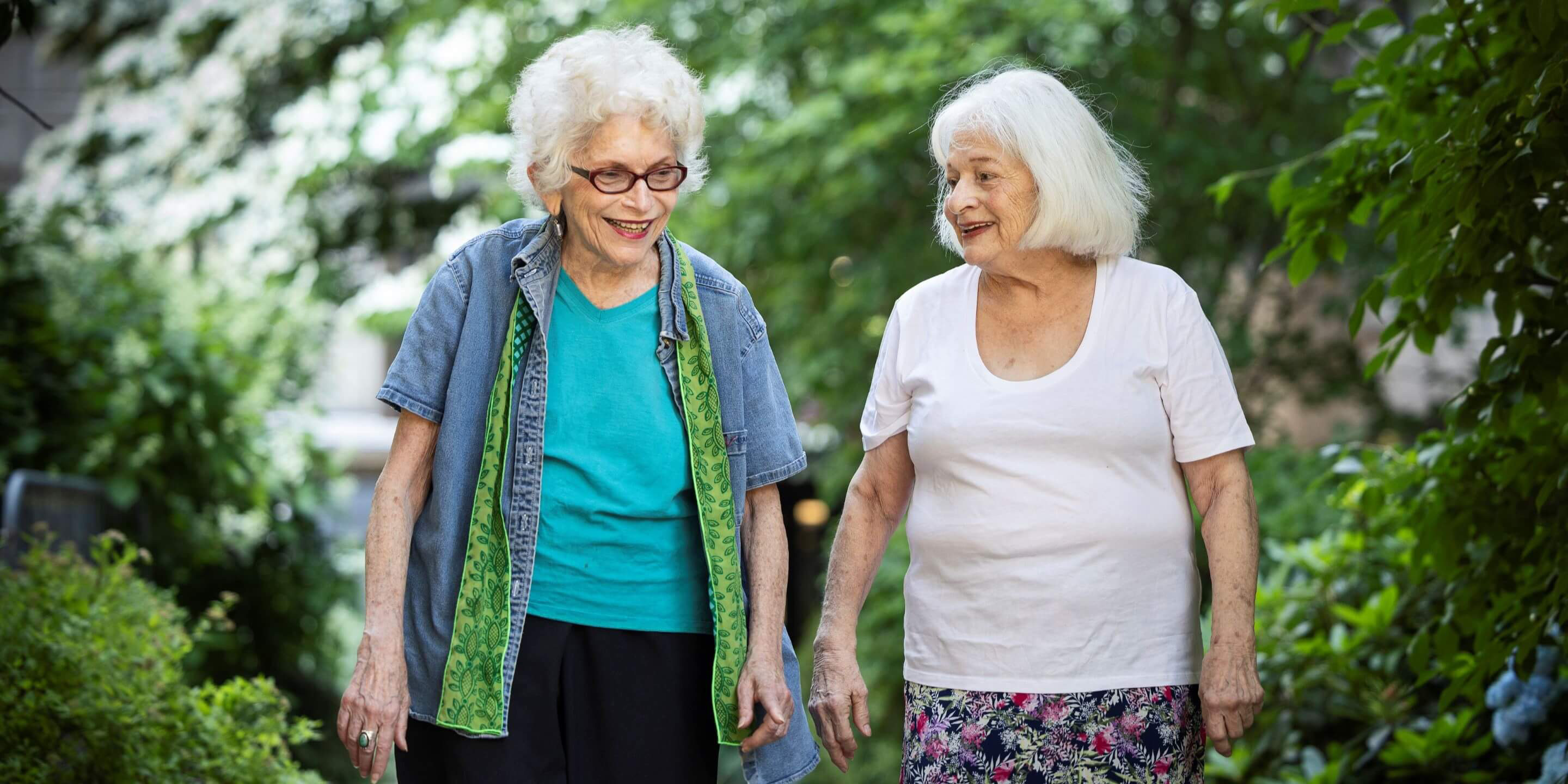 Two older women walking together