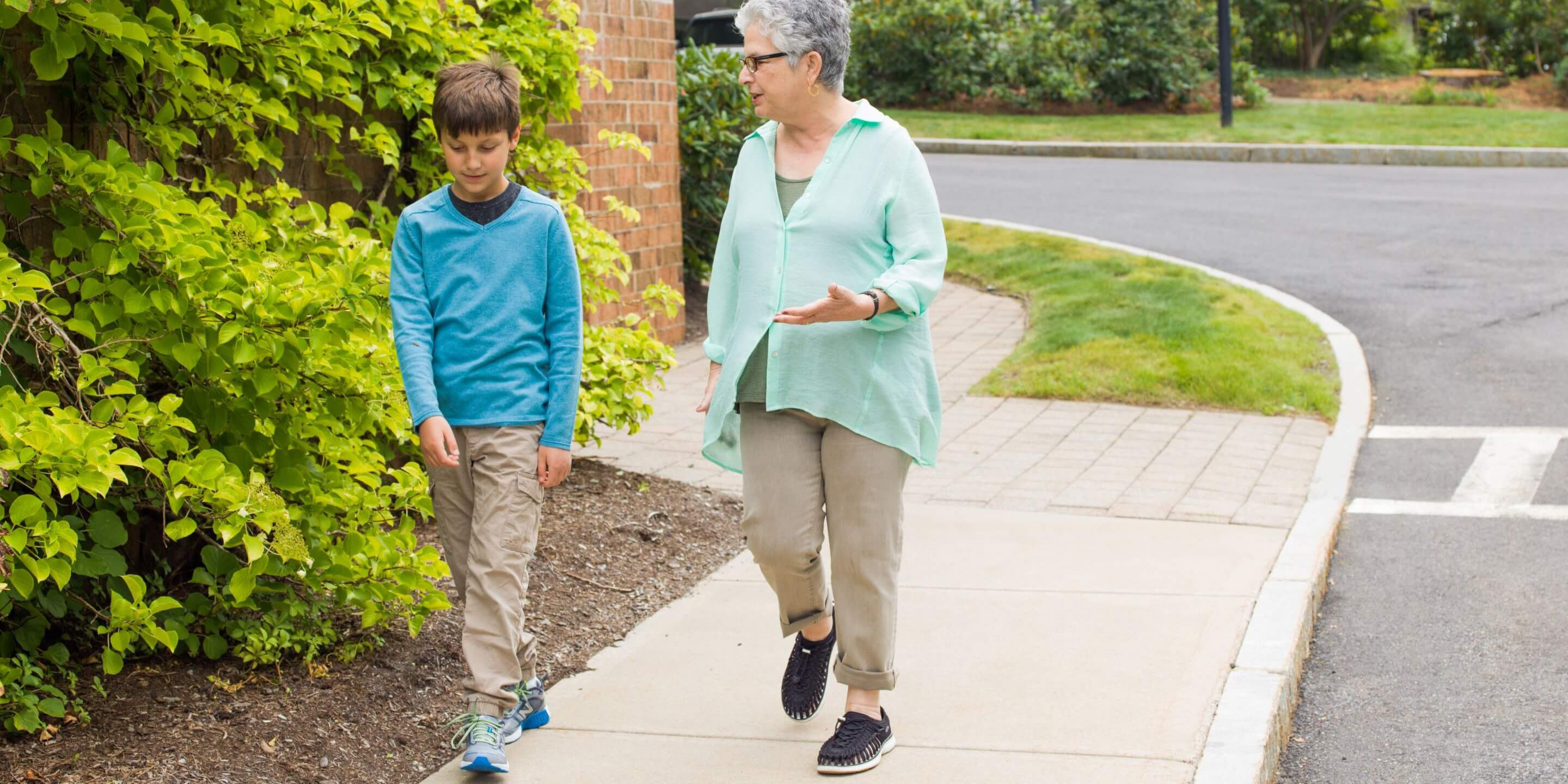 Older woman walking with young boy