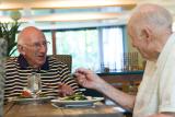 Two senior men having a meal