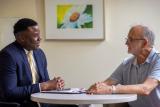 Planner sitting with older man