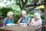 Senior women sitting together with books