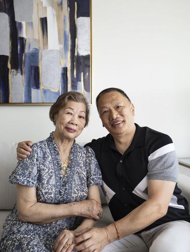 An older woman and her son sitting on a couch.