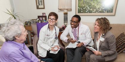 Dr. Jennifer Rhodes-Kropf and students from Harvard Medical School visit with a Center Communities of Brookline resident in their apartment.