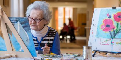 A female resident paints a photo.