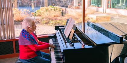 A resident plays the piano at Orchard Cove in Canton, MA