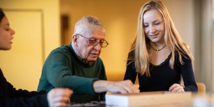 Young girl sitting with older male 