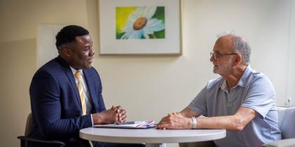 Planner sitting with older man