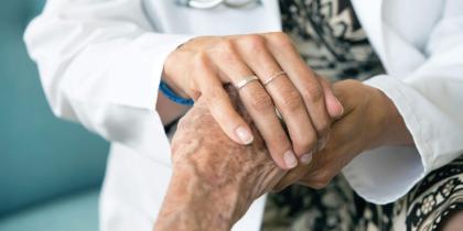 Doctor holding senior's hand