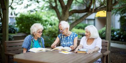 Senior women sitting together with books