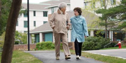 Two older women walking together outside