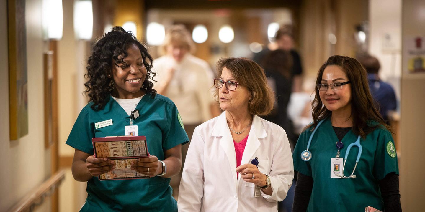 Three nurses in a hallway