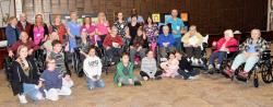 A  group pose for the camera at a multigenerational Russian-speaking program event.