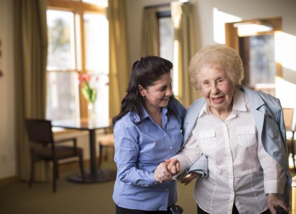 Women helping senior woman