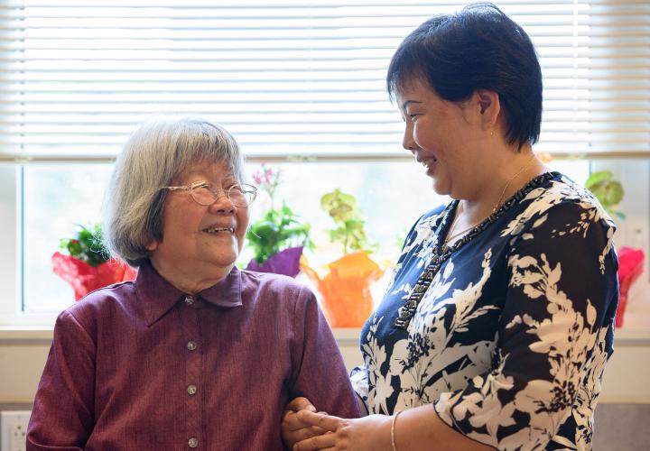 A participant in Hebrew SeniorLife’s Great Days for Seniors program in Brighton, MA smiles at a staff member.