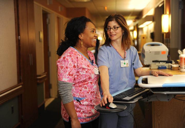 Two nurses working in hallway