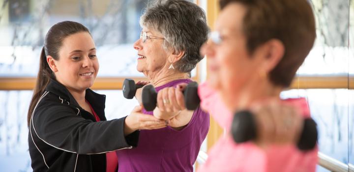 Residents enjoy the state-of-the-art fitness center at NewBridge on the Charles in Dedham, MA